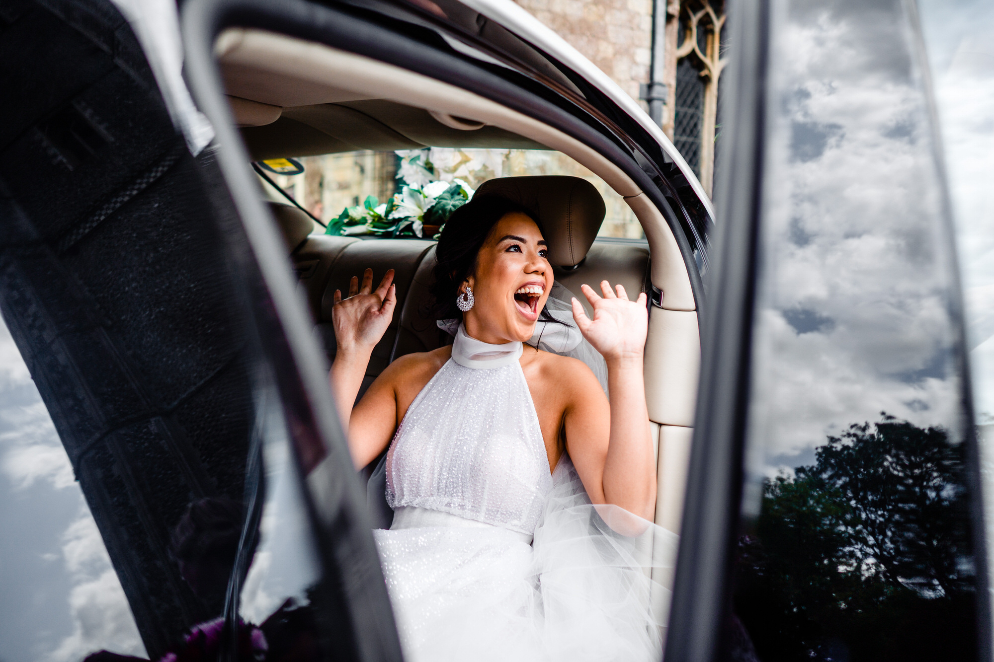 Bride Getting Out Of Car At Wymondham Abbey